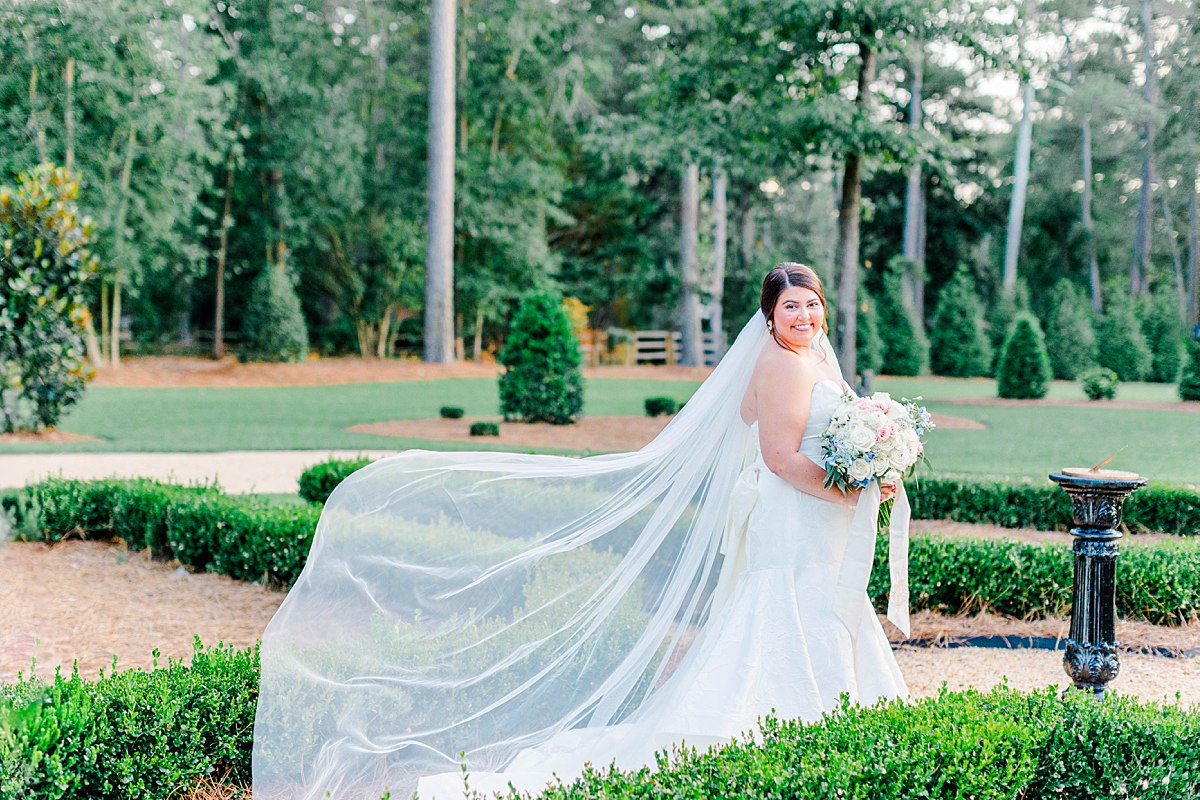 elegant cathedral veil toss during wedding images in North Carolina