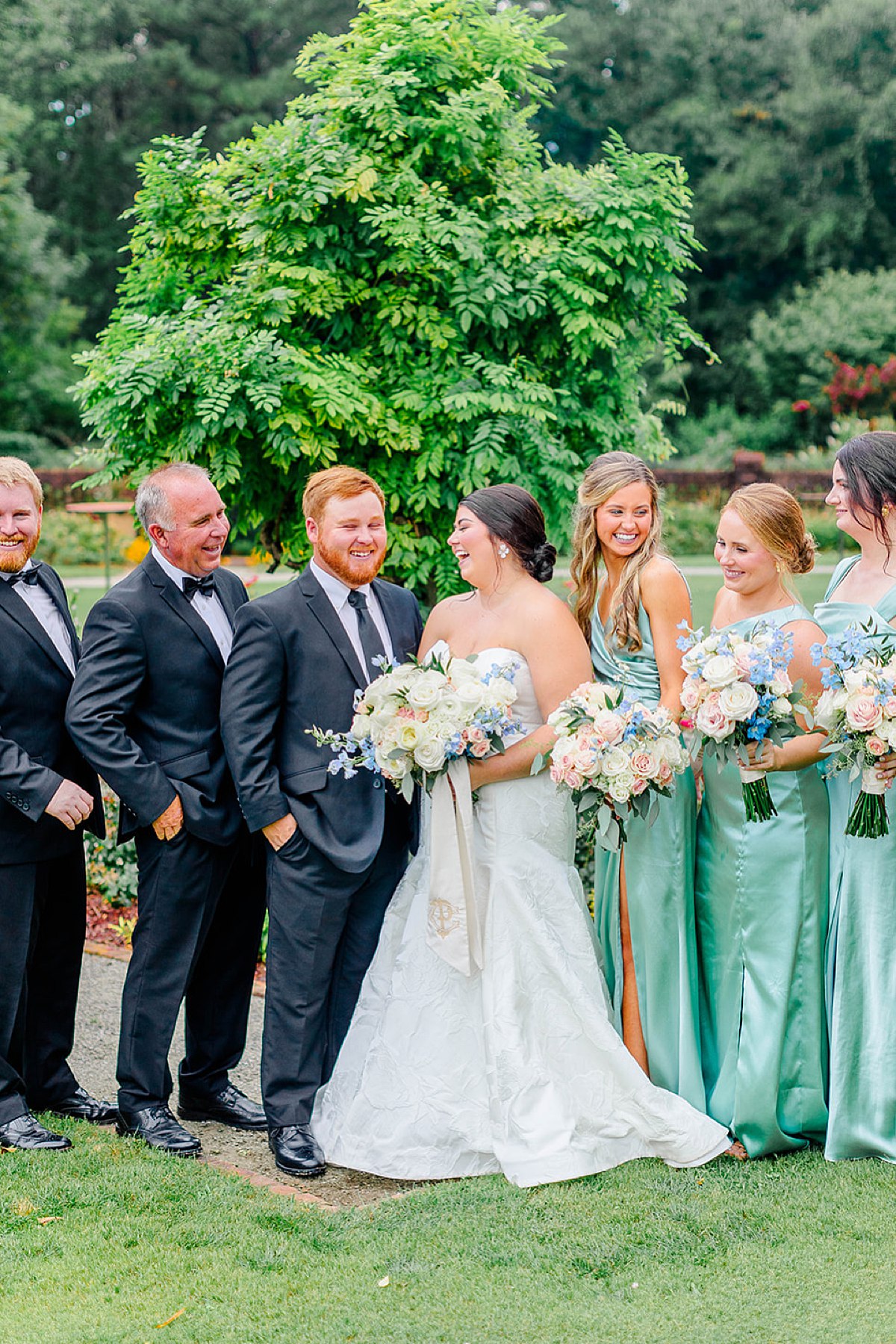 bridal party laughing on summer wedding day in nc