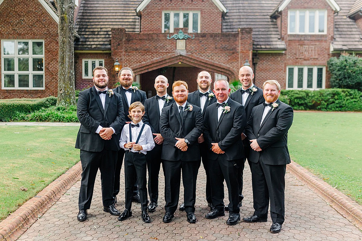 summer wedding photos of groom and groomsmen in classic black and white 