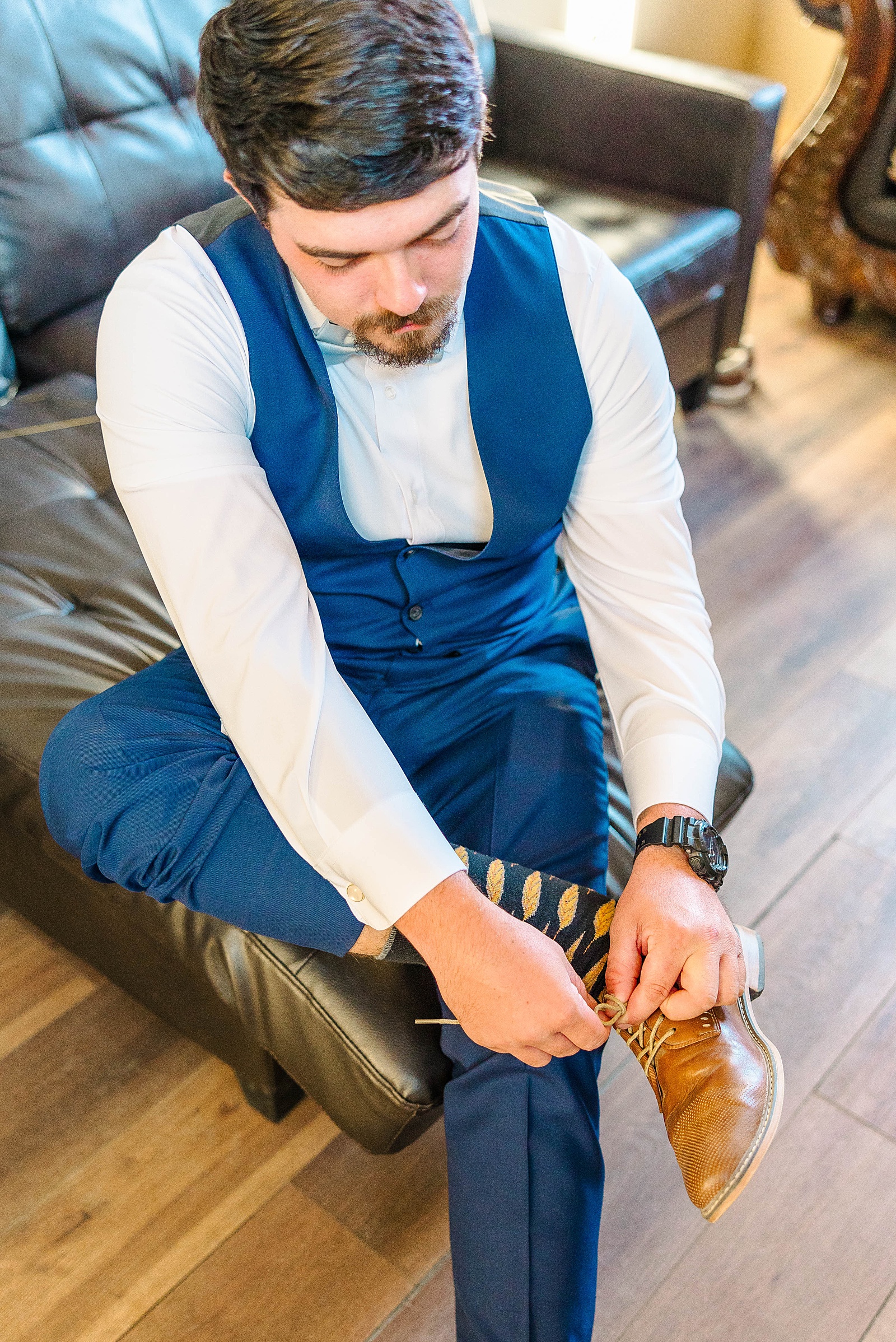 Groom getting ready in a blue tux for fall wedding in NC. 