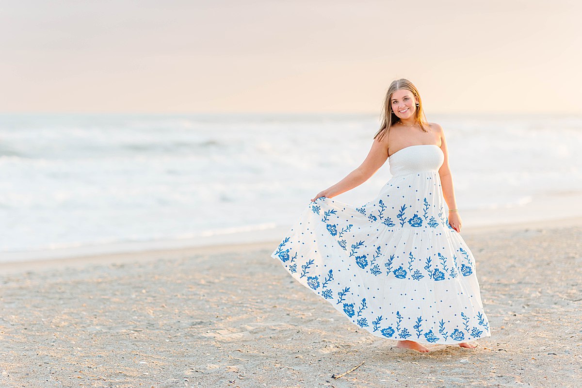 High school senior girl spring photo session in Beaufort and Atlantic Beach, North Carolina with the sands of Atlantic Beach in strapless white maxi dress.