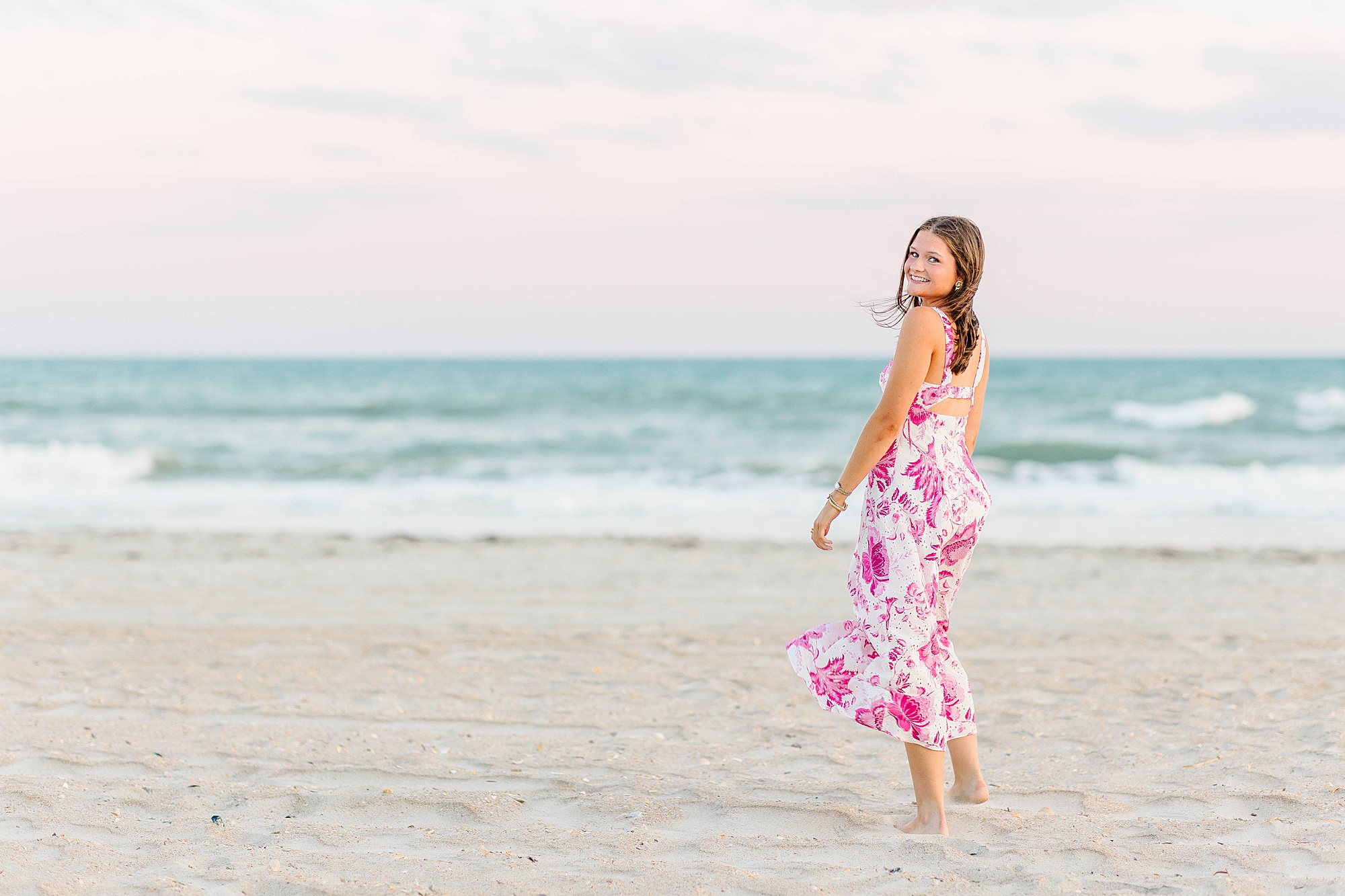 High school senior photos in pink and white dress on Atlantic Beach, NC