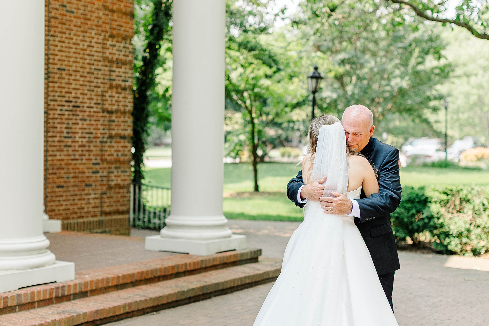 Bride first look with dad in front of the chapel at Meredith College