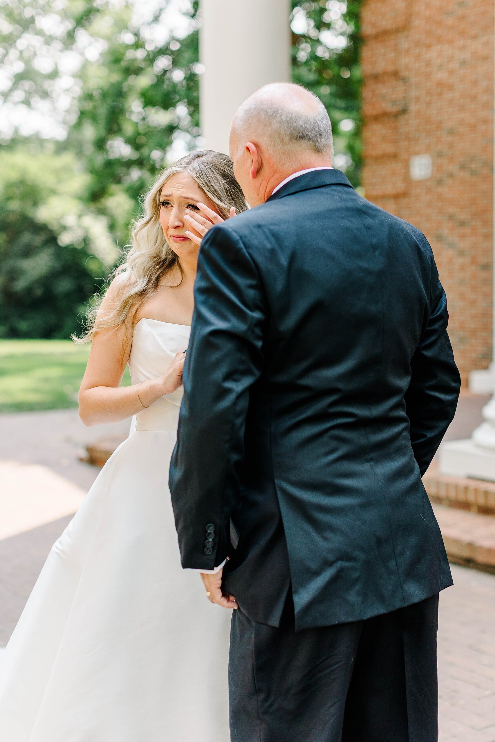 Bride crying during first look with her dad at wedding at The Meredith Capel 