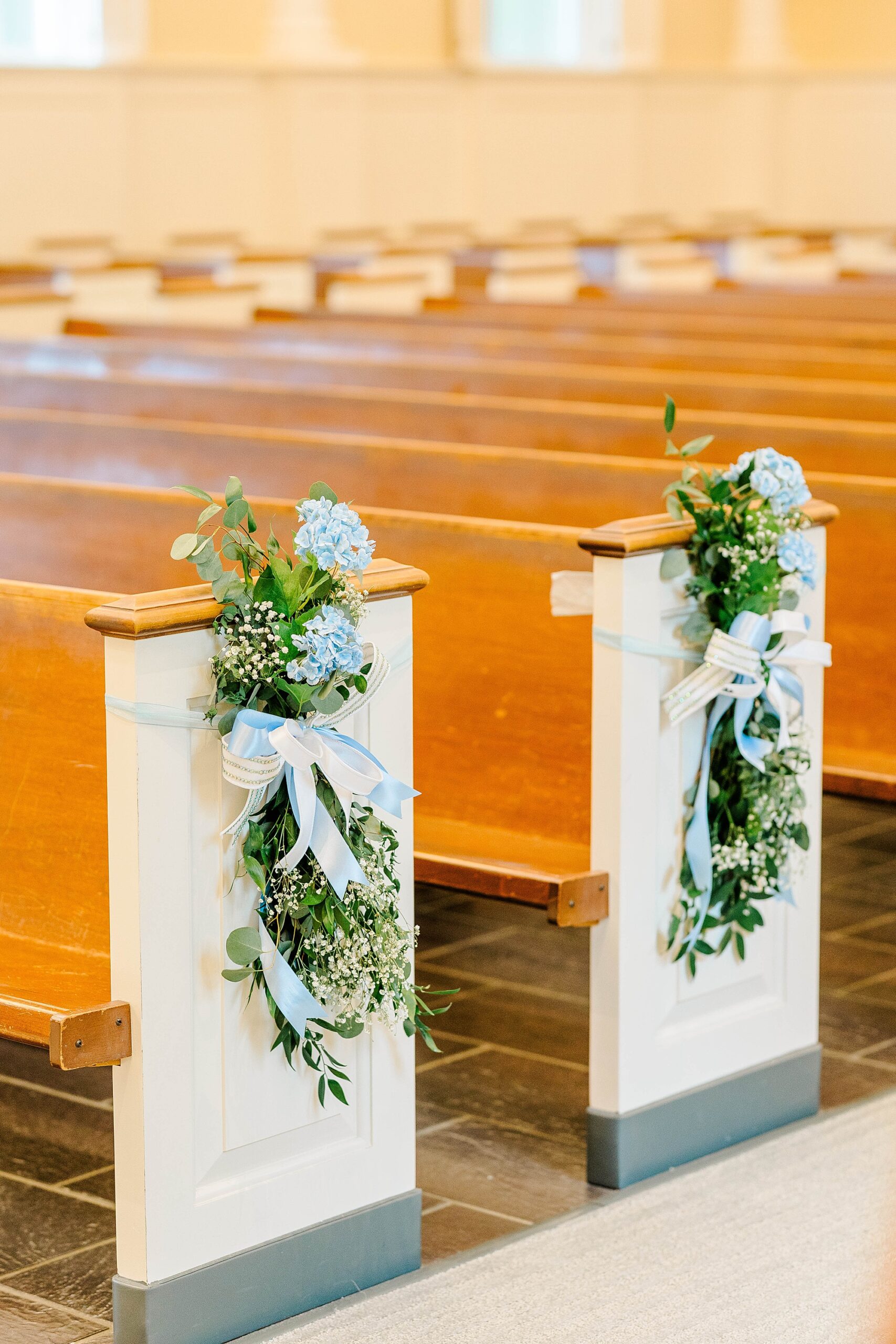 Pew florals for wedding decor at Meredith College Chapel