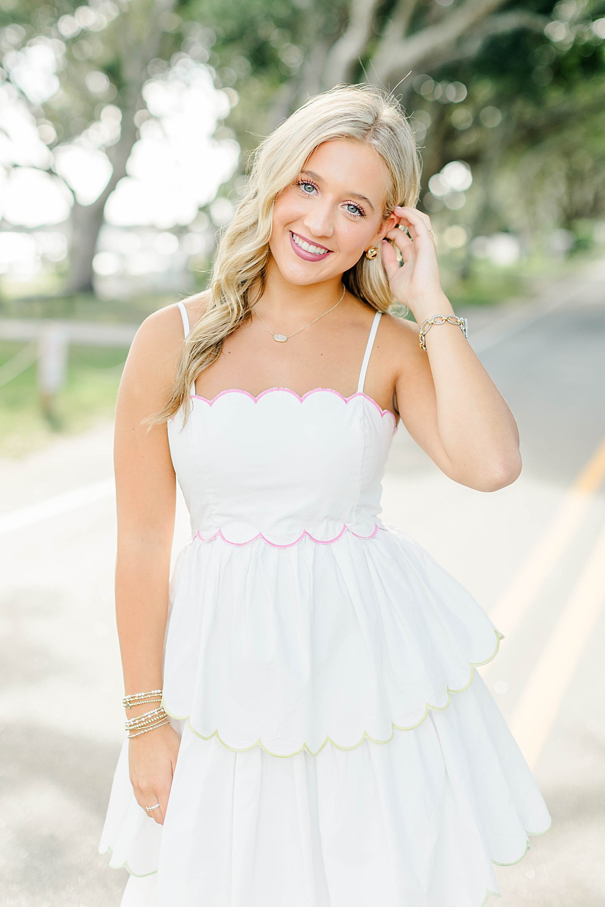 Senior girl in a white scalloped dress during her coastal senior session in Beaufort, NC.