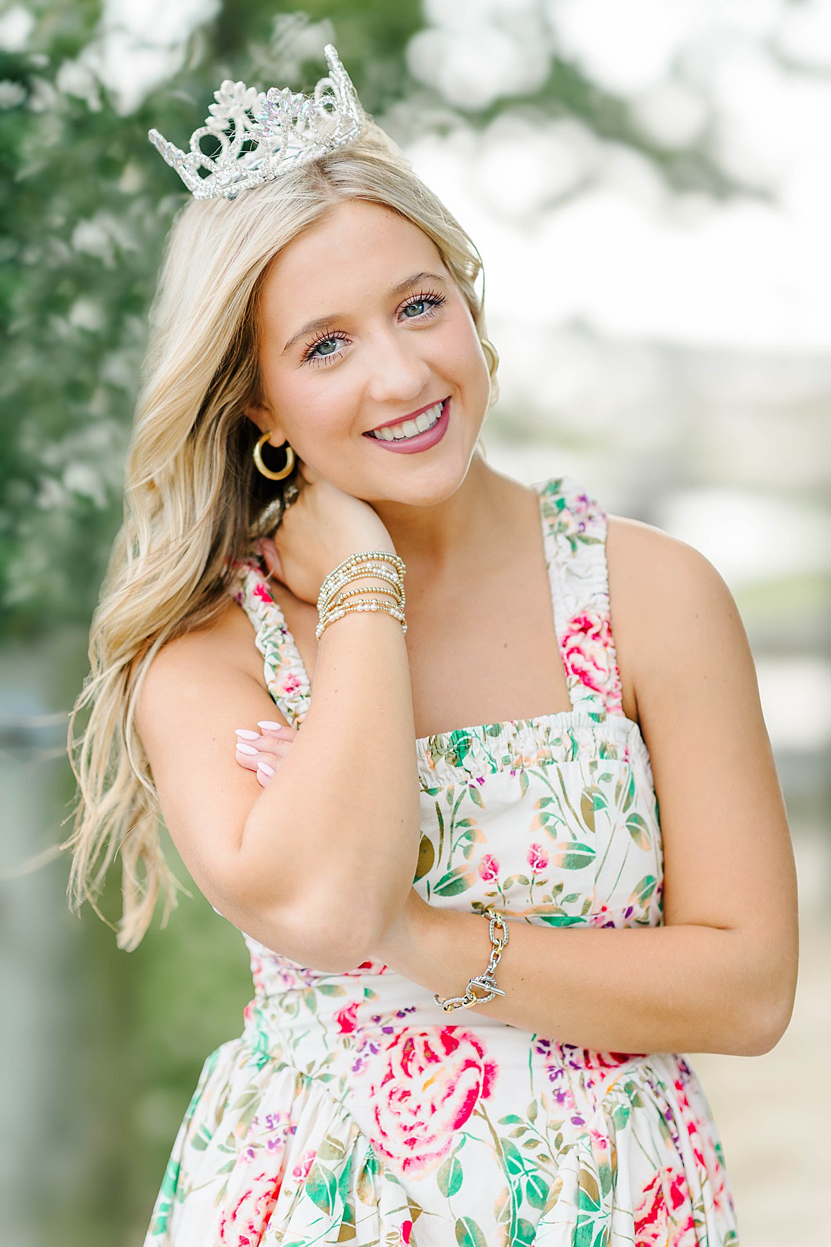 Senior girl in a floral, cross back dress with a tiara during her coastal senior session in Beaufort, NC.
